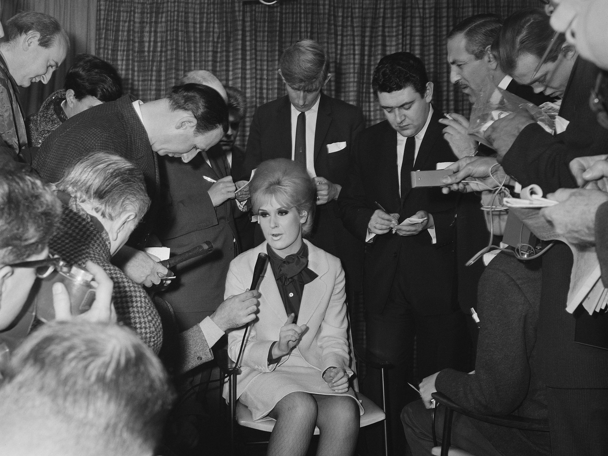 Speaking to the press in 1964
