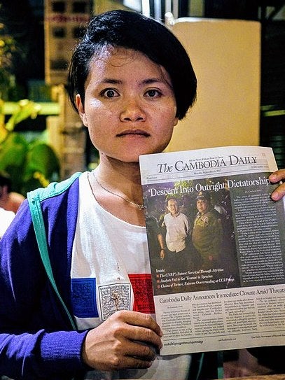 Journalist Len Leng holding the final issue of the Cambodia Daily in September 2017