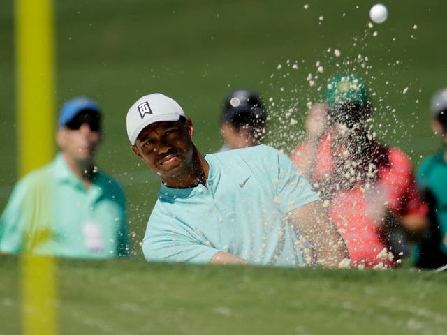 Tiger Woods hits out of the bunker