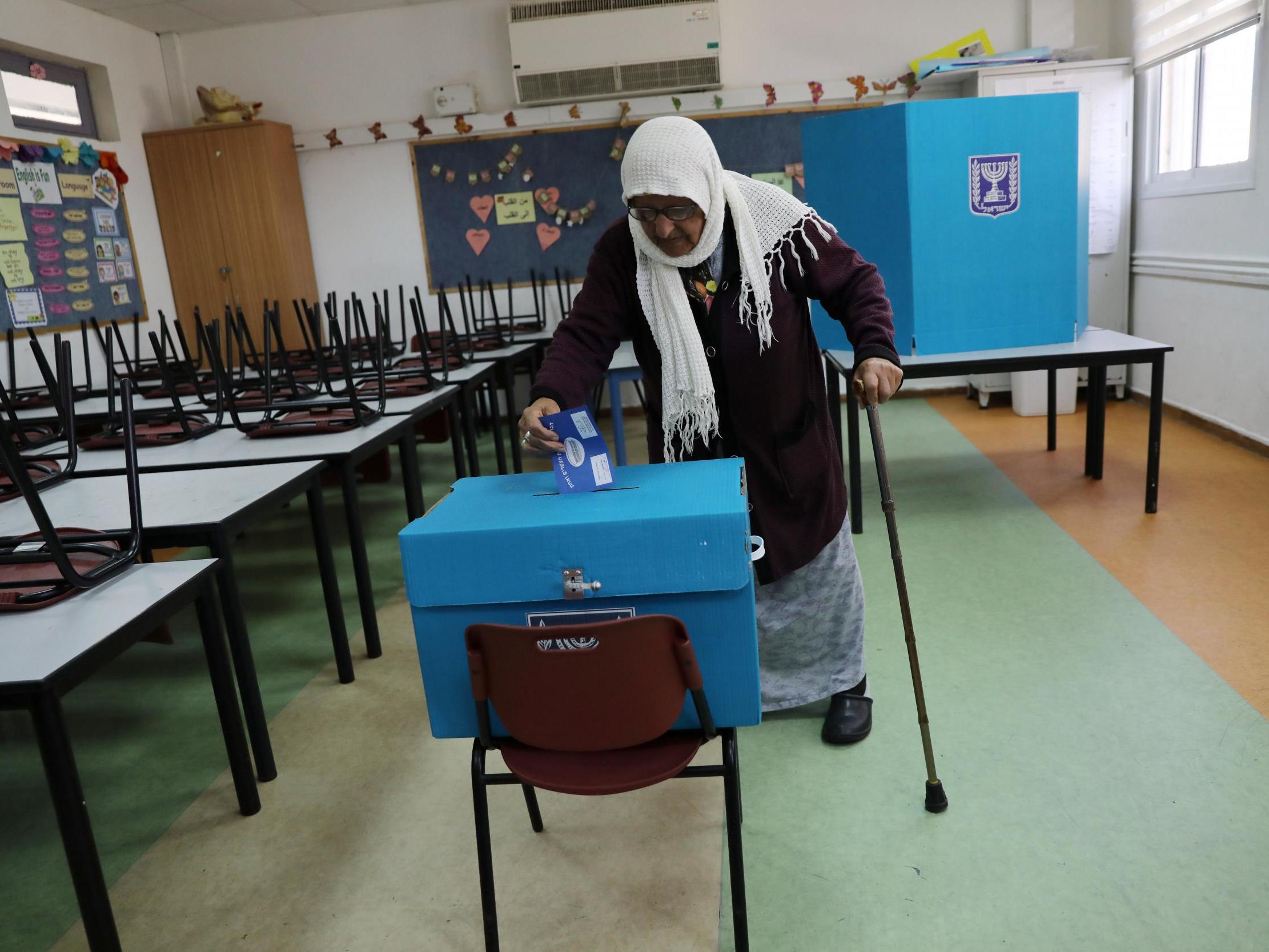 An Arab-Israeli woman casts her ballot at a polling station in Haifa
