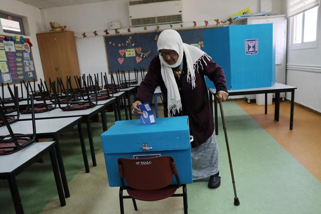 An Arab-Israeli woman casts her ballot at a polling station in Haifa