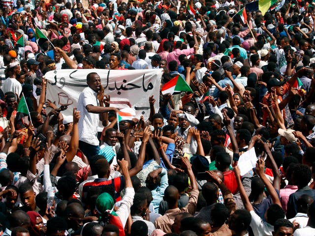 Sudanese demonstrators gather in a street in central Khartoum on April 11, 2019, immediatly after one of Africa's longest-serving presidents was toppled by the army