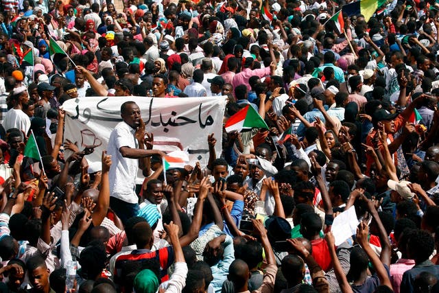 Sudanese demonstrators gather in a street in central Khartoum on April 11, 2019, immediatly after one of Africa's longest-serving presidents was toppled by the army