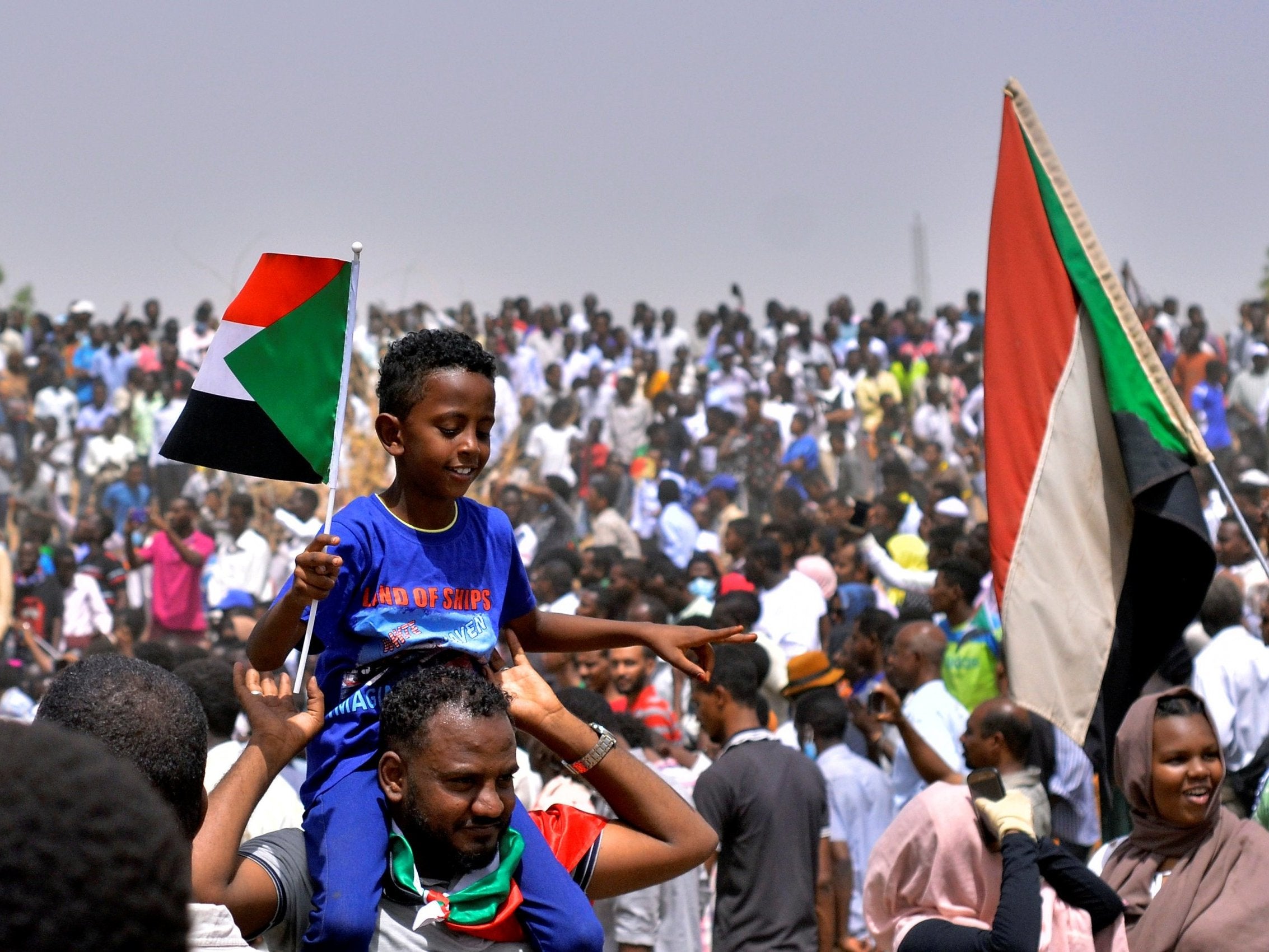 Demonstrators chant slogans and carry Sudanese flags in Khartoum yesterday