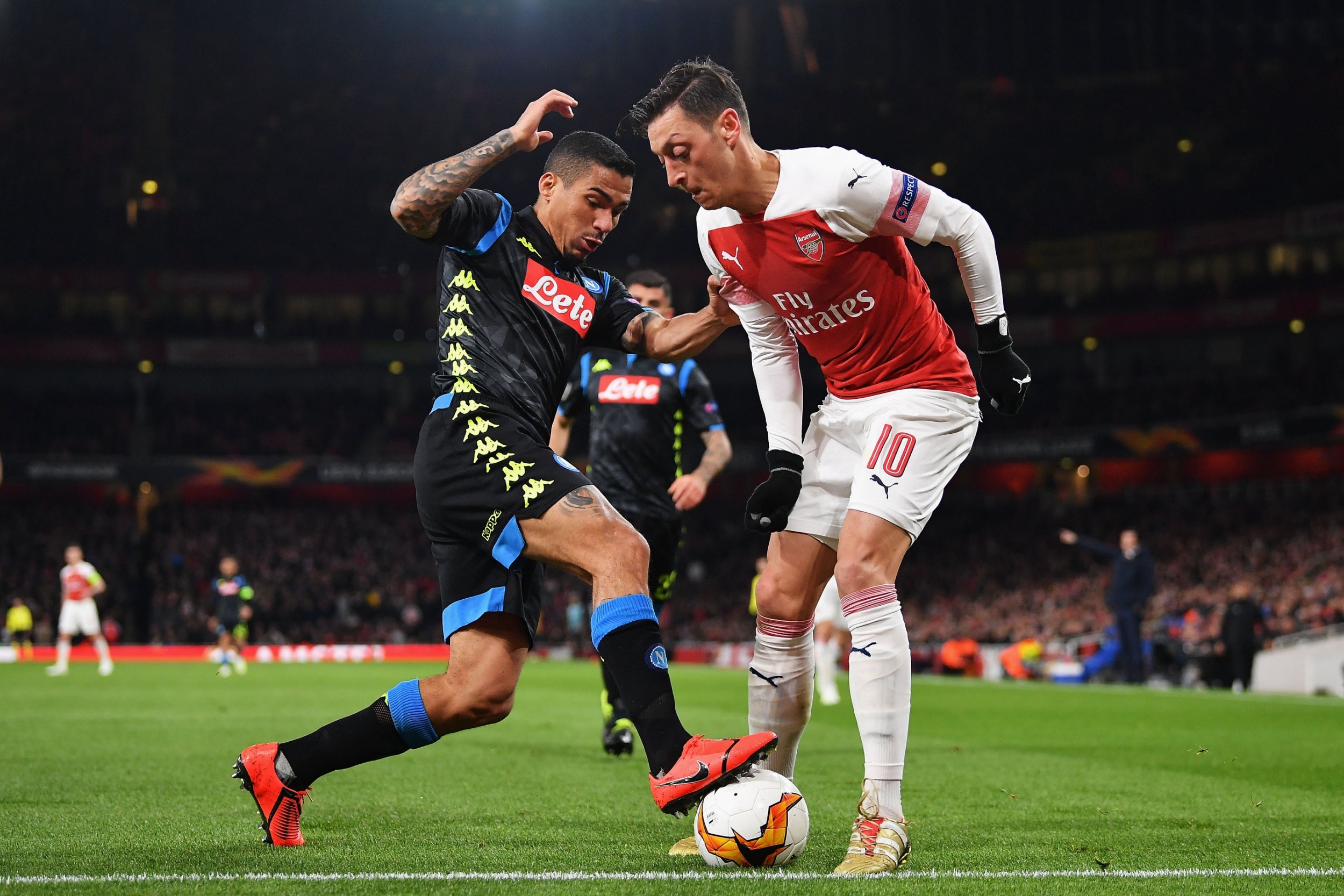 Mesut Ozil is tackled