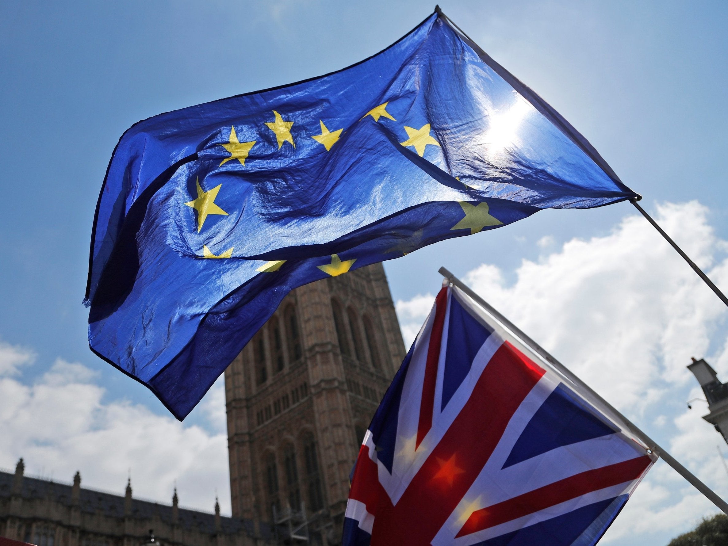 Protester flags fly opposite the Houses of Parliament in London 11 April 2019.