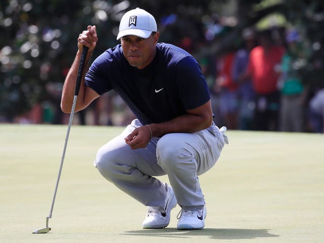 Tiger Woods of the US lines up his putt