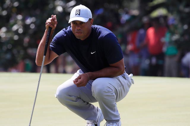 Tiger Woods of the US lines up his putt
