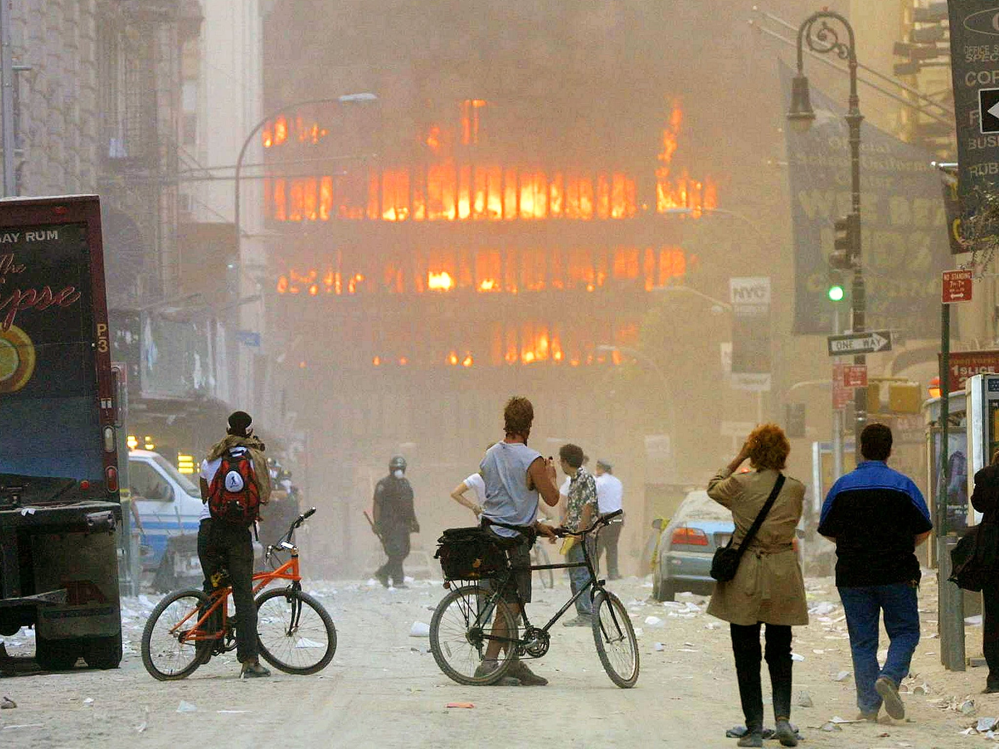 People stand transfixed as flames sweep through one of the Towers (Getty)