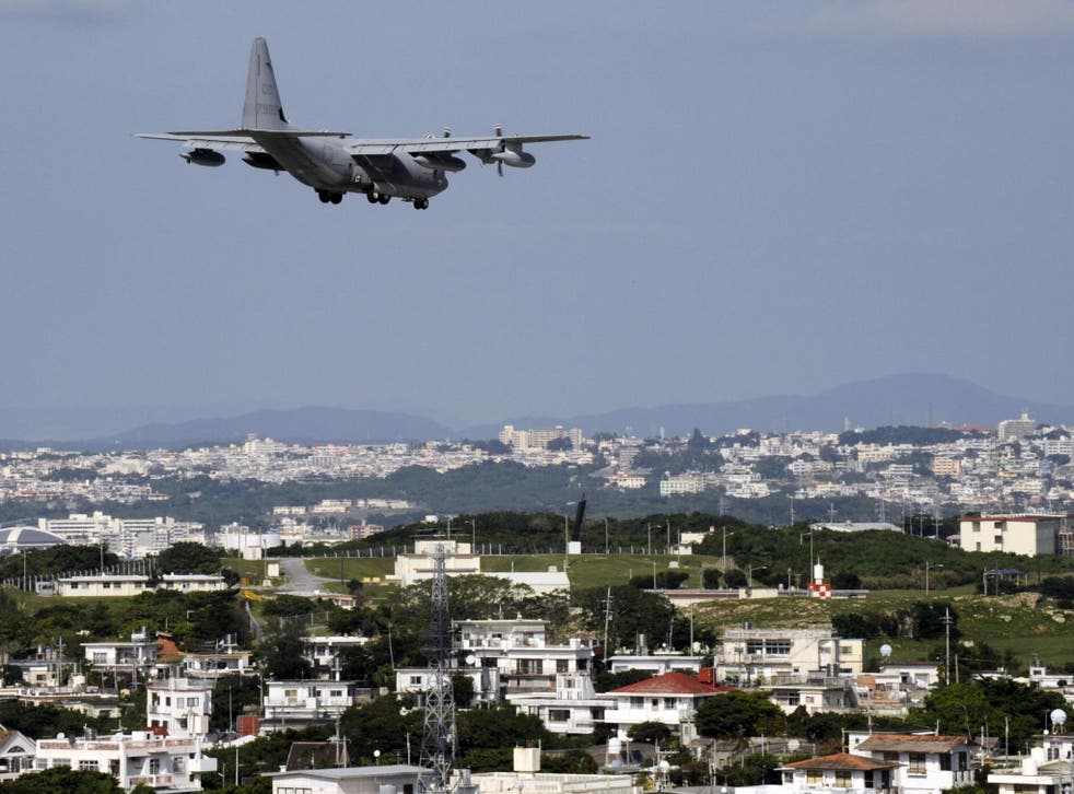 A military cargo plane landing at the US Marine Corps Futenma Air Base in Okinawa