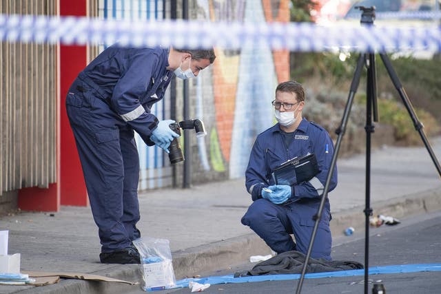 Forensic police examine items at the scene of a multiple shooting outside Love Machine nightclub in Melbourne