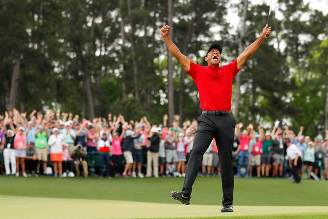 Tiger Woods celebrates after his winning putt