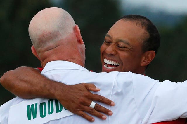 Tiger Woods embraces caddy Joe LaCava after winning the 2019 Masters