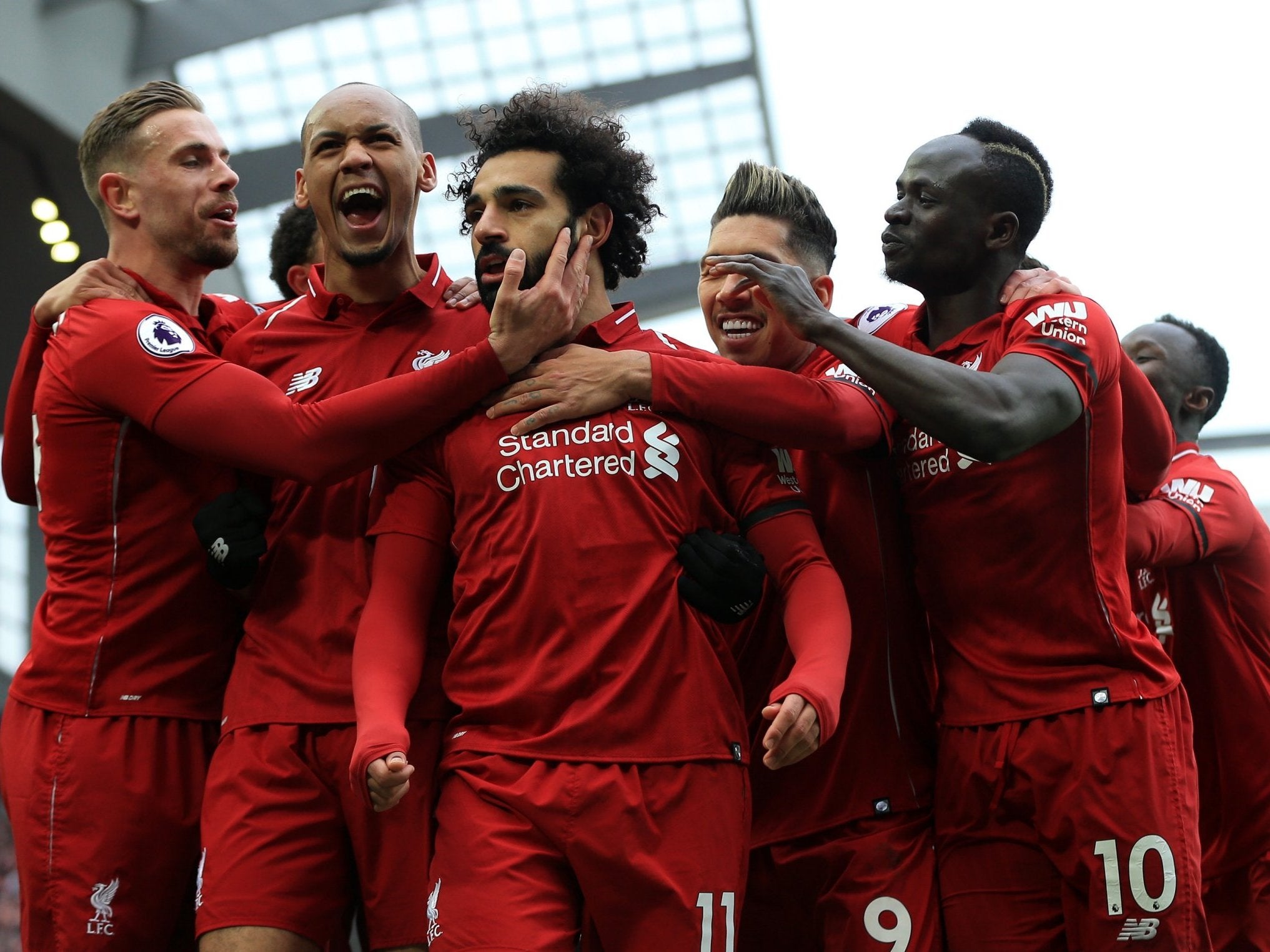 Mohamed Salah is mobbed by his teammates after scoring