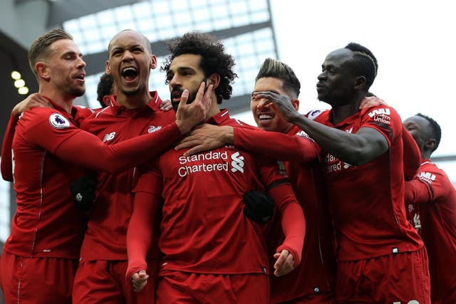 Mohamed Salah is mobbed by his teammates after scoring