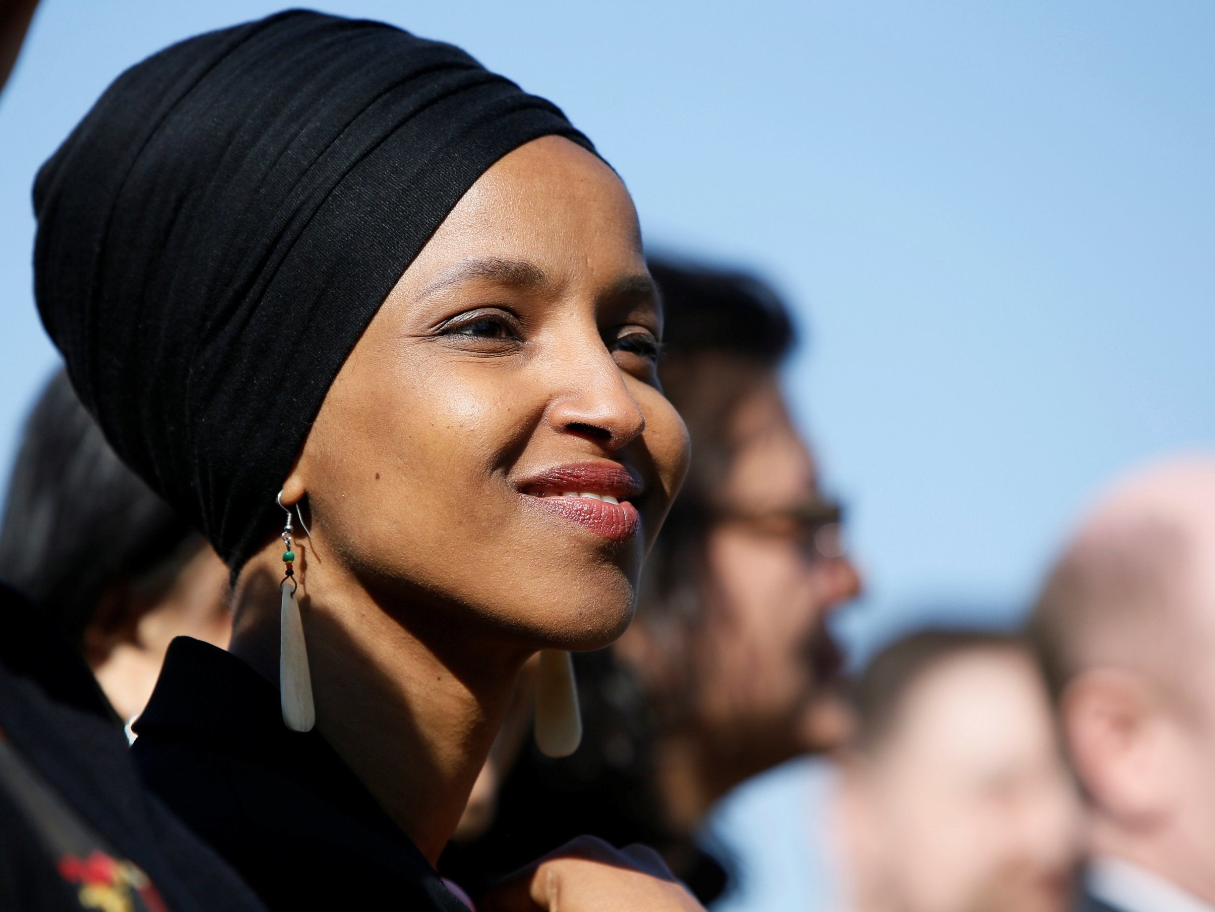 Ilhan Omar (D-MN) smiles at a news conference by members of the US Congress "to announce legislation to repeal President Trump's 'Muslim ban"