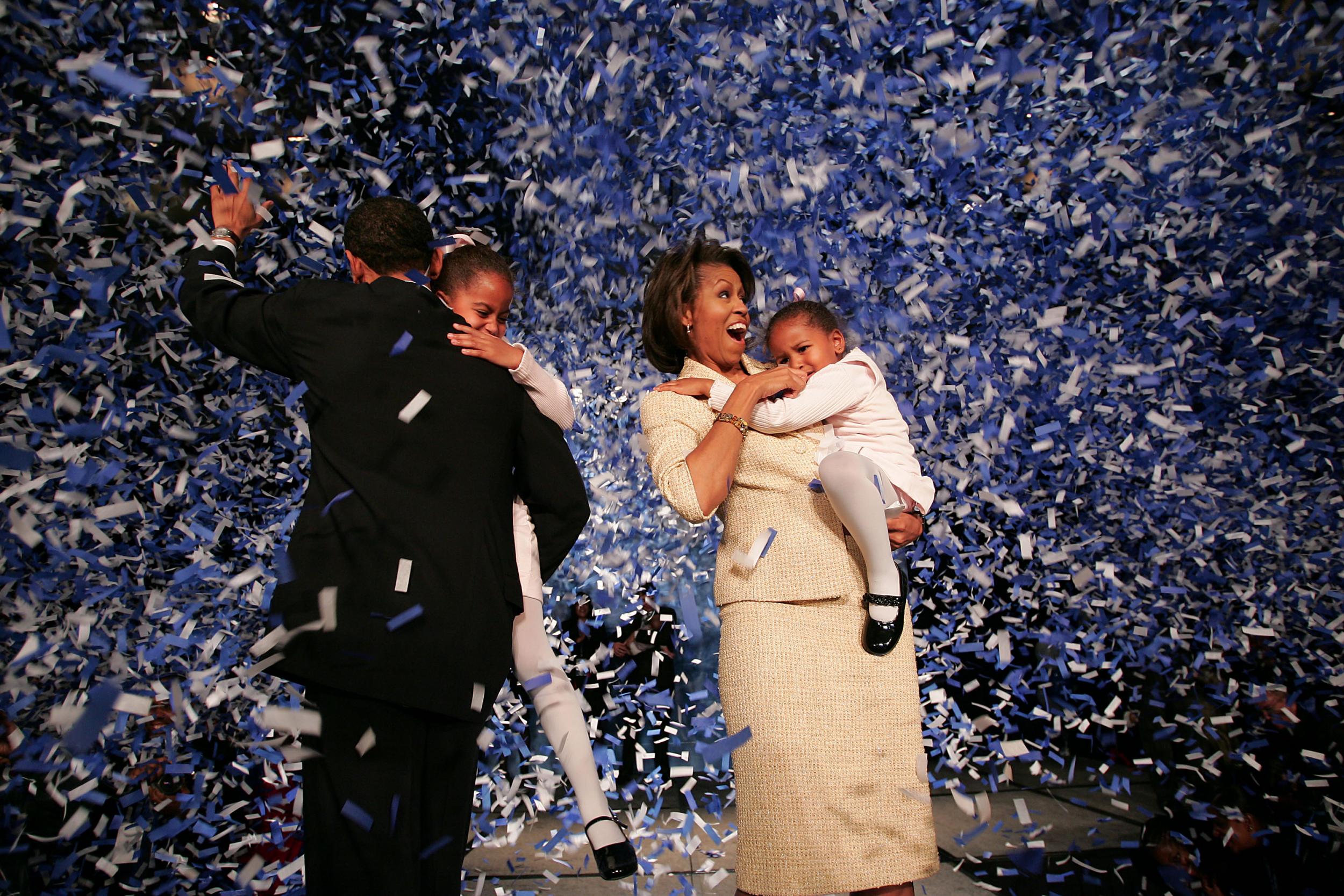 Candidate for the U.S. Senate Barack Obama (D-IL) (L) holding his daughter Malia with wife Michelle and youngest daughter Sasha (R) celebrate his victory with supporters over Repulican rival Alan Keyes November 2, 2004 in Chicago, Illinois