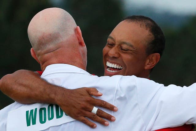 Tiger Woods celebrates with caddie Joe LaCava