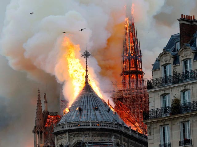 Smoke and flames rise during a fire at the landmark Notre-Dame Cathedral in central Paris