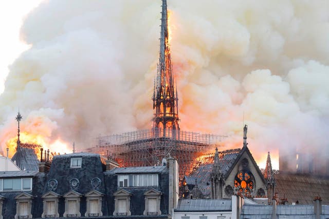 Smoke and flames rise during a fire at the landmark Notre-Dame Cathedral in central Paris