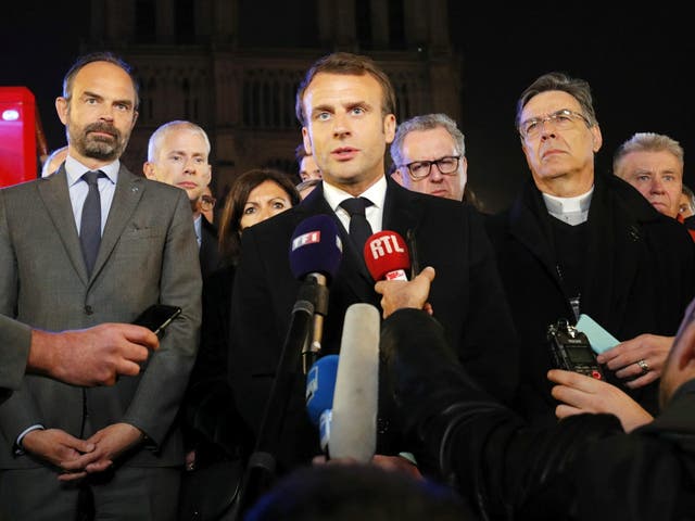 Emmanuel Macron speaks near the Notre Dame cathedral
