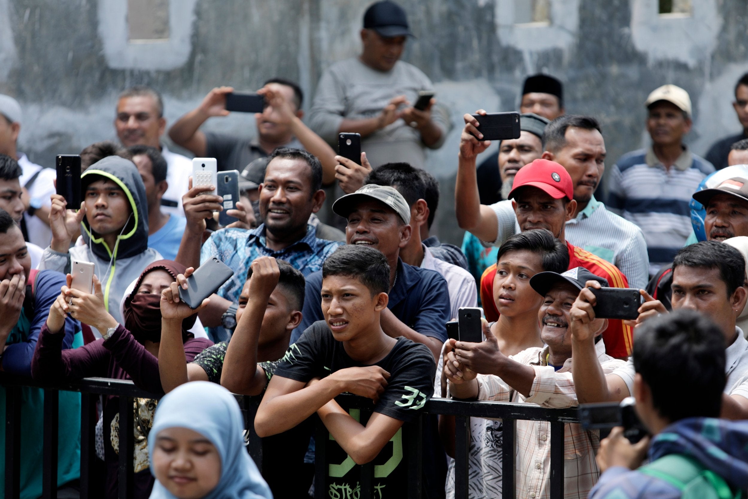 People use their mobile phones to record the public caning