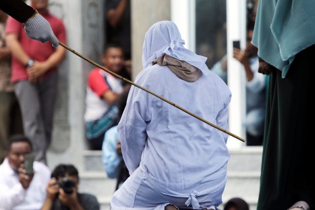 An Acehnese woman faces public caning as punishment for sexual relations without marriage in Banda Aceh