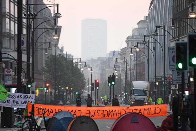 Activists block the road near Marble Arch on the second day of an environmental protest by the Extinction Rebellion group, in London on April 16