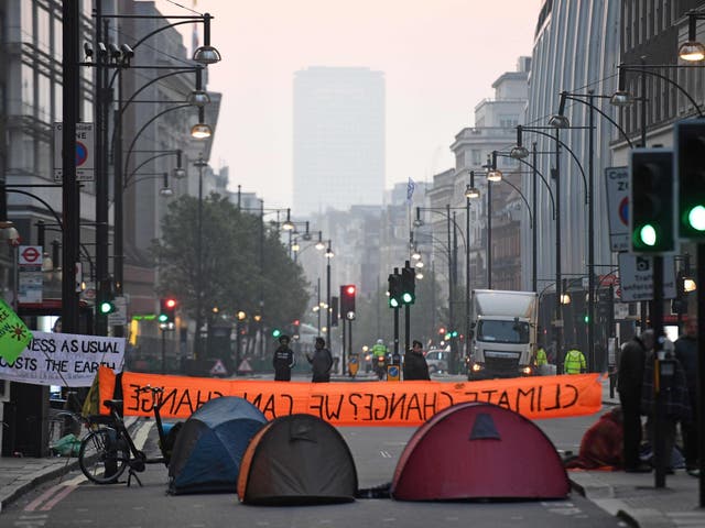 Activists block the road near Marble Arch on the second day of an environmental protest by the Extinction Rebellion group, in London on April 16