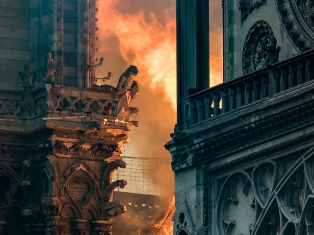 Flames and smoke billow around the gargoyles decorating the roof of the Notre Dame after a fire broke out on 5 April 2019