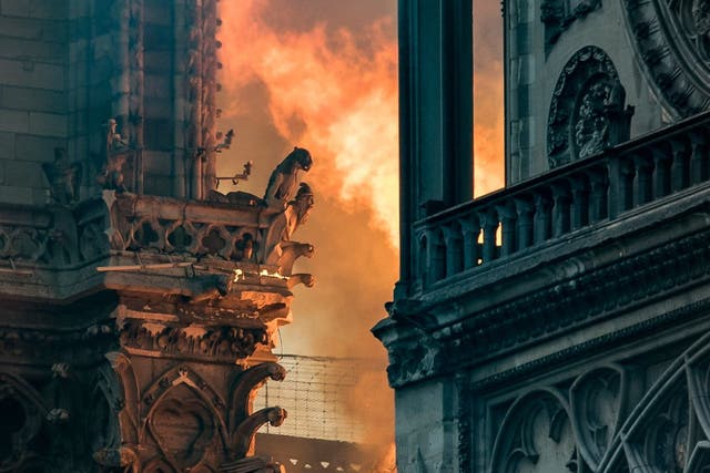 Flames and smoke billow around the gargoyles decorating the roof of the Notre Dame after a fire broke out on 5 April 2019