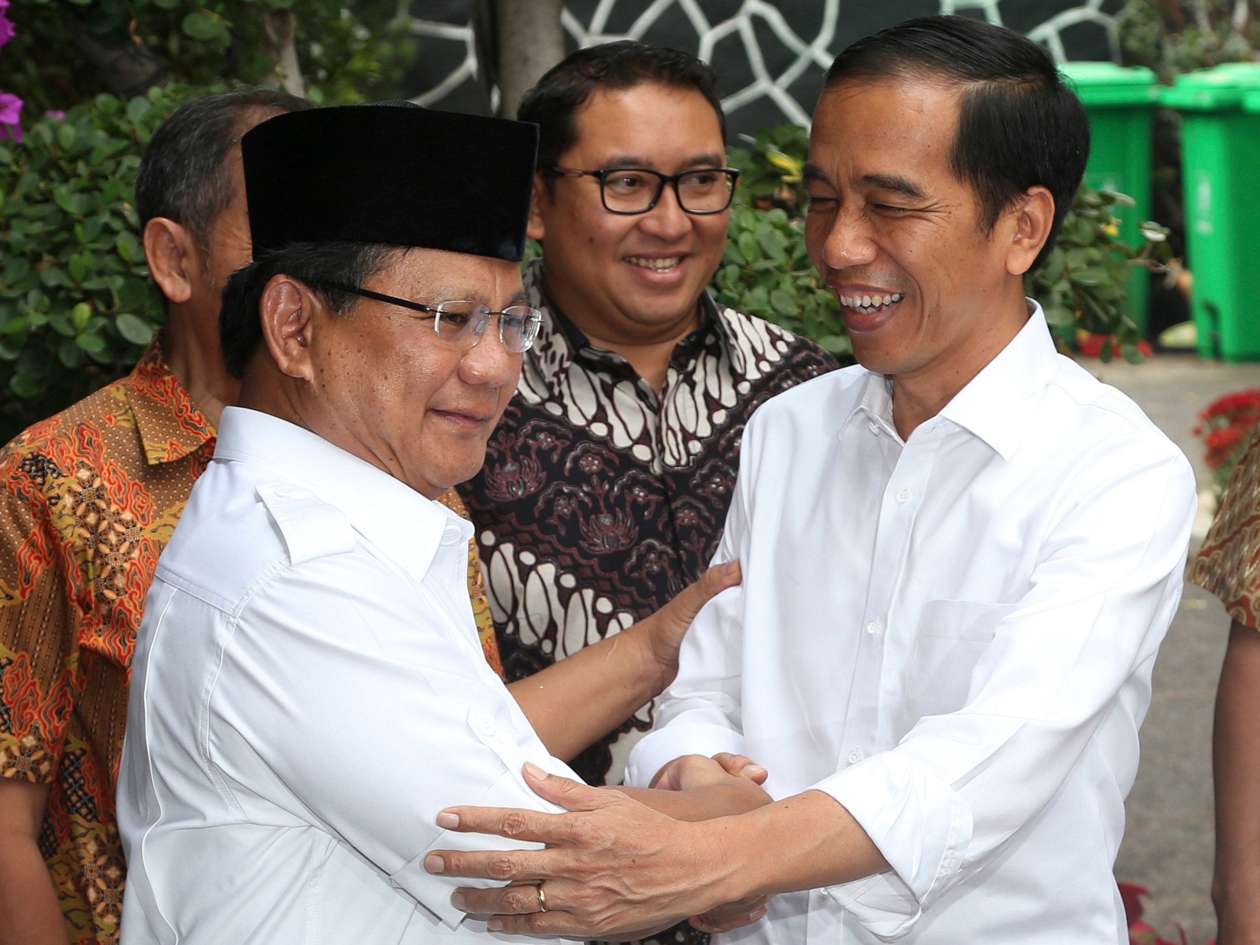 File image shows then Indonesia's President-elect Joko Widodo, right, with his political rival Prabowo Subianto, after the 2014 election. This year's vote is a re-run of that contest