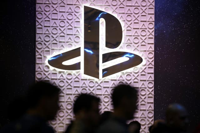 Attendees walk by the Sony PlayStation booth at the 2019 GDC Game Developers Conference on March 20, 2019 in San Francisco, California