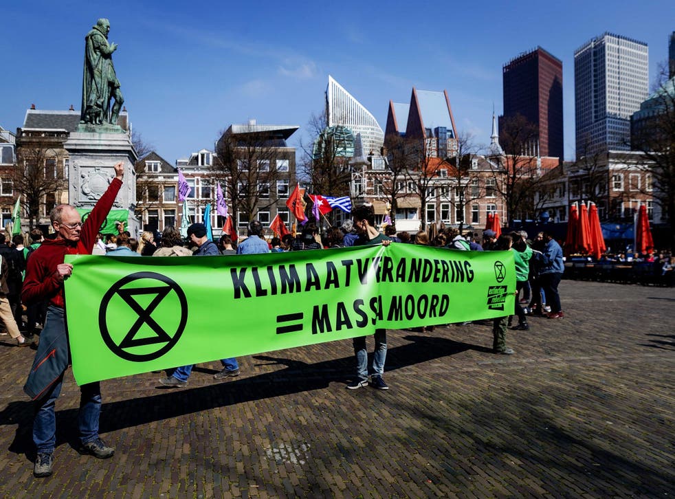 Climate change protestors demonstrate in front of the Dutch parliament in The Hague