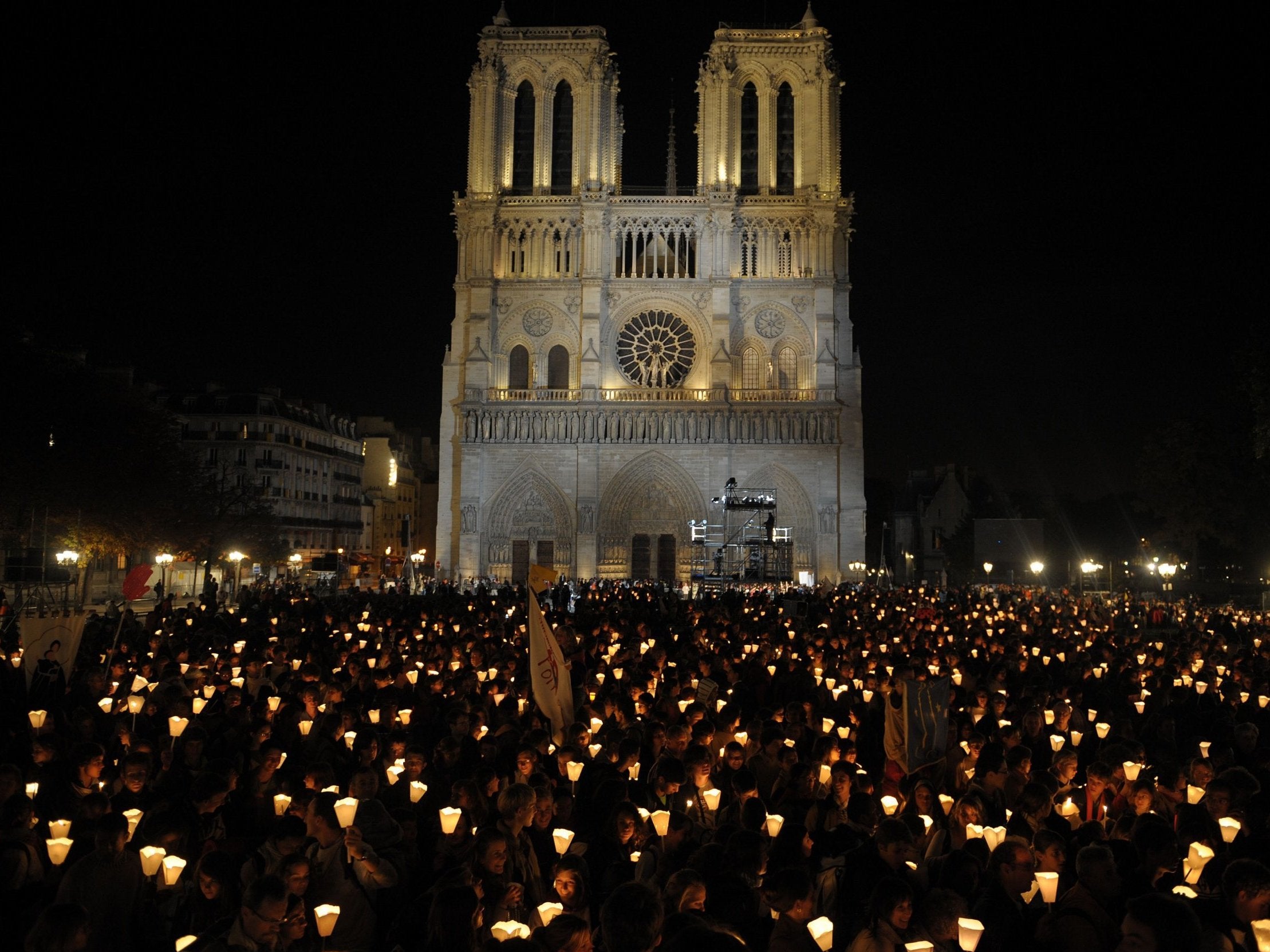 Faithful hold candles during a "Path of light" procession between Notre Dame Cathedral during the four-day visit in France of Pope Benedict XVI in 2008