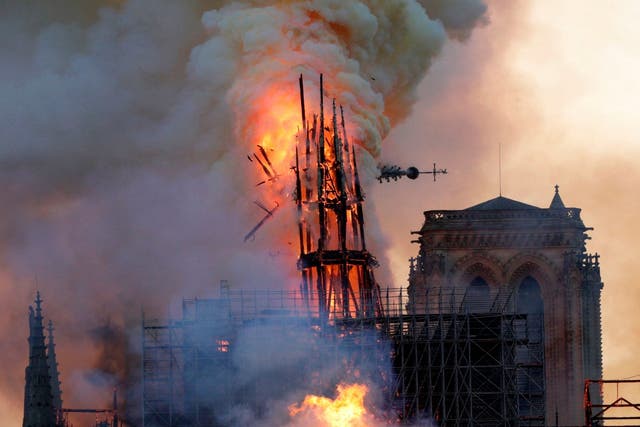 The steeple collapses as smoke and flames engulf the Notre-Dame Cathedral in Paris on 15 April 2019