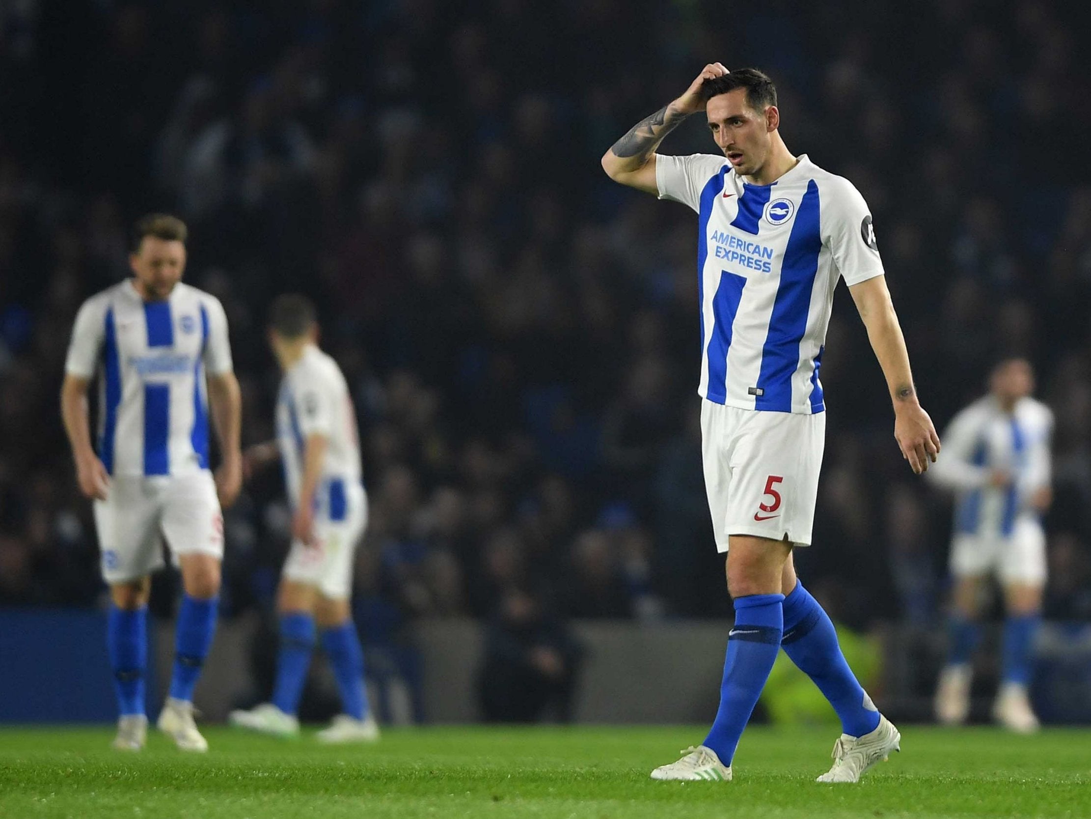 Brighton’s players leave the field dejected