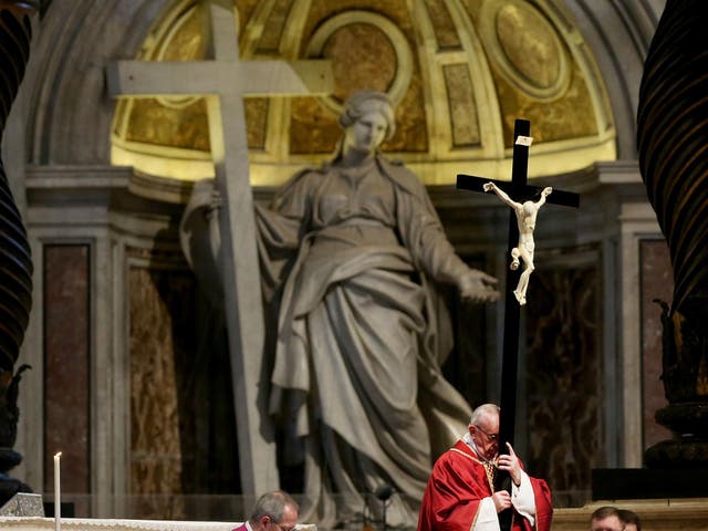 Pope Francis holds the Holy cross during the Celebration of the Lord's Passion at St. Peter's Basilica in Vatican City, Vatican on 14 April 2017