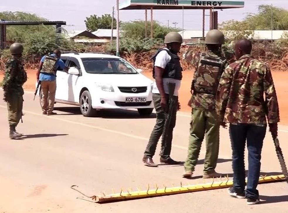 Kenyan armed police stand guard at a checkpoint
