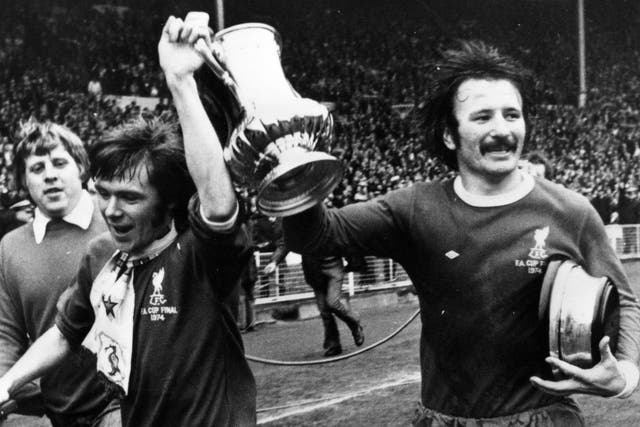 Silver Smith: the defender and his Liverpool teammate Brian Hall (left) parade the FA Cup after the 3-0 win over Newcastle in 1974
