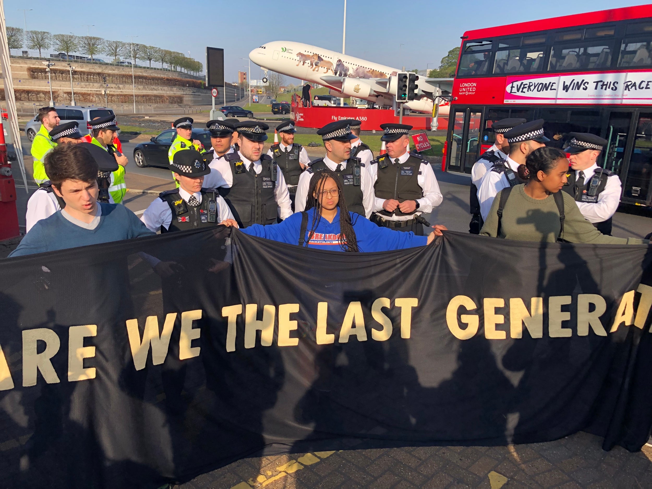 Four teenage protesters, holding a banner reading “Are we the last generation”