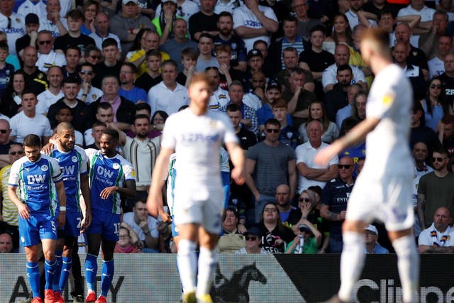 Leeds' players look on after Gavin Massey celebrates Wigan's second goal