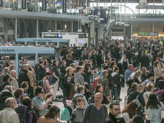 Travellers pack onto Waterloo station concourse in London yesterday