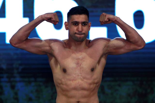Amir Khan poses during the weigh-in