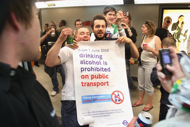 Partygoers join in a cocktail party on the London Underground on 31 May 2008, a day before the consumption of alcohol became illegal on public transport in the capital