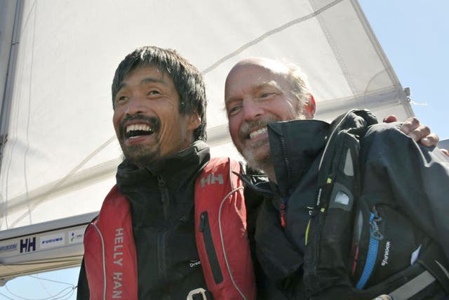 Two-month voyage: Mitsuhiro Iwamoto celebrates with his navigator Doug Smith yesterday after sailing the Pacific