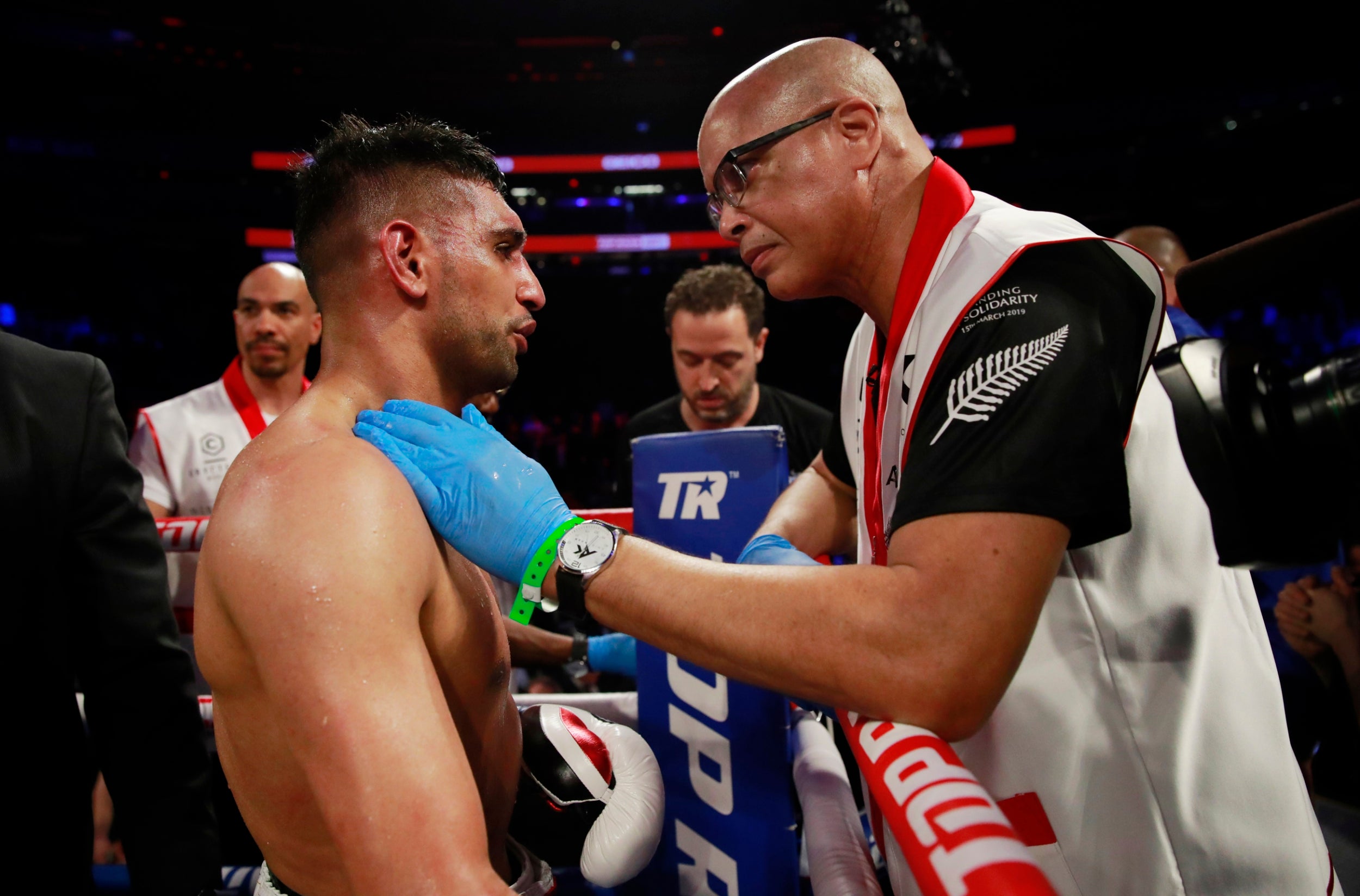 Virgil Hunter consoles Khan after the fight is waved off (Reuters)
