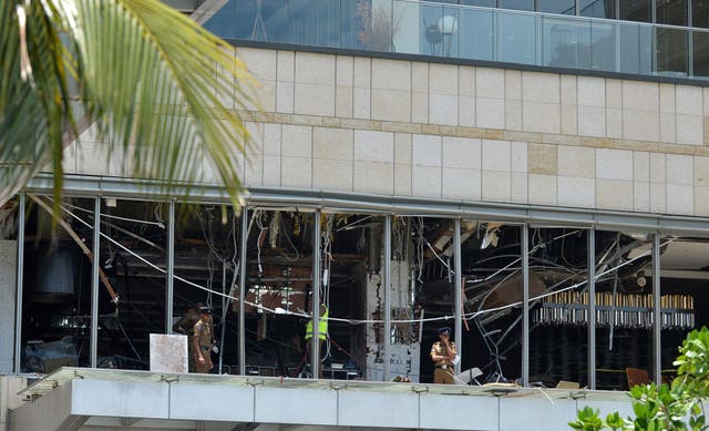 Sri Lankan police stand at the site of an explosion in a restaurant area of the luxury Shangri-La Hotel in Colombo