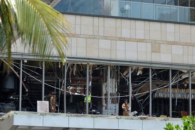 Sri Lankan police stand at the site of an explosion in a restaurant area of the luxury Shangri-La Hotel in Colombo