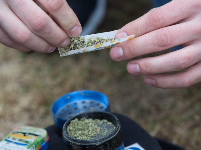 A marijuana cigarette is prepared during the annual 4/20 rally on Parliament Hill in Ottawa, Ontario, on 20 April 2019.